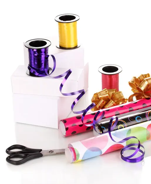 Empaque de regalo con cinta metalizada formando moños y detalles llamativos – SOCO Cintas Adhesivas.